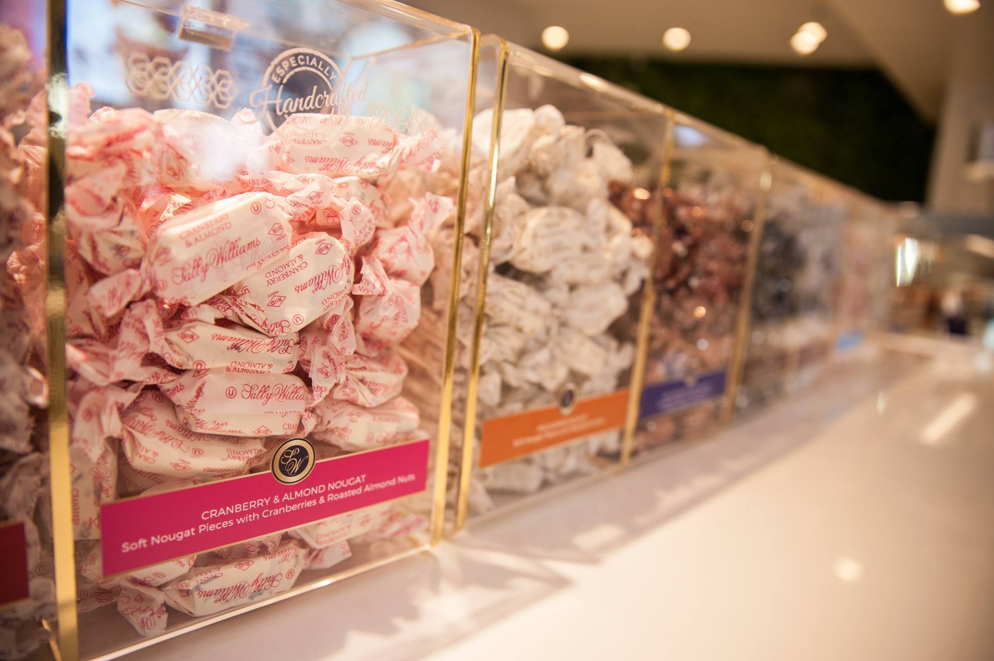 Clear acrylic sweet box display with hinged cover and branding