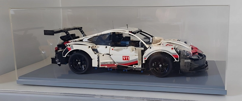 Acrylic presentation case displaying a model car on a plinth.
