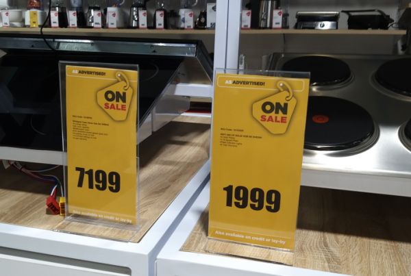 Illuminated in-store signage and retail display stands — acrylic sign fabrication Johannesburg